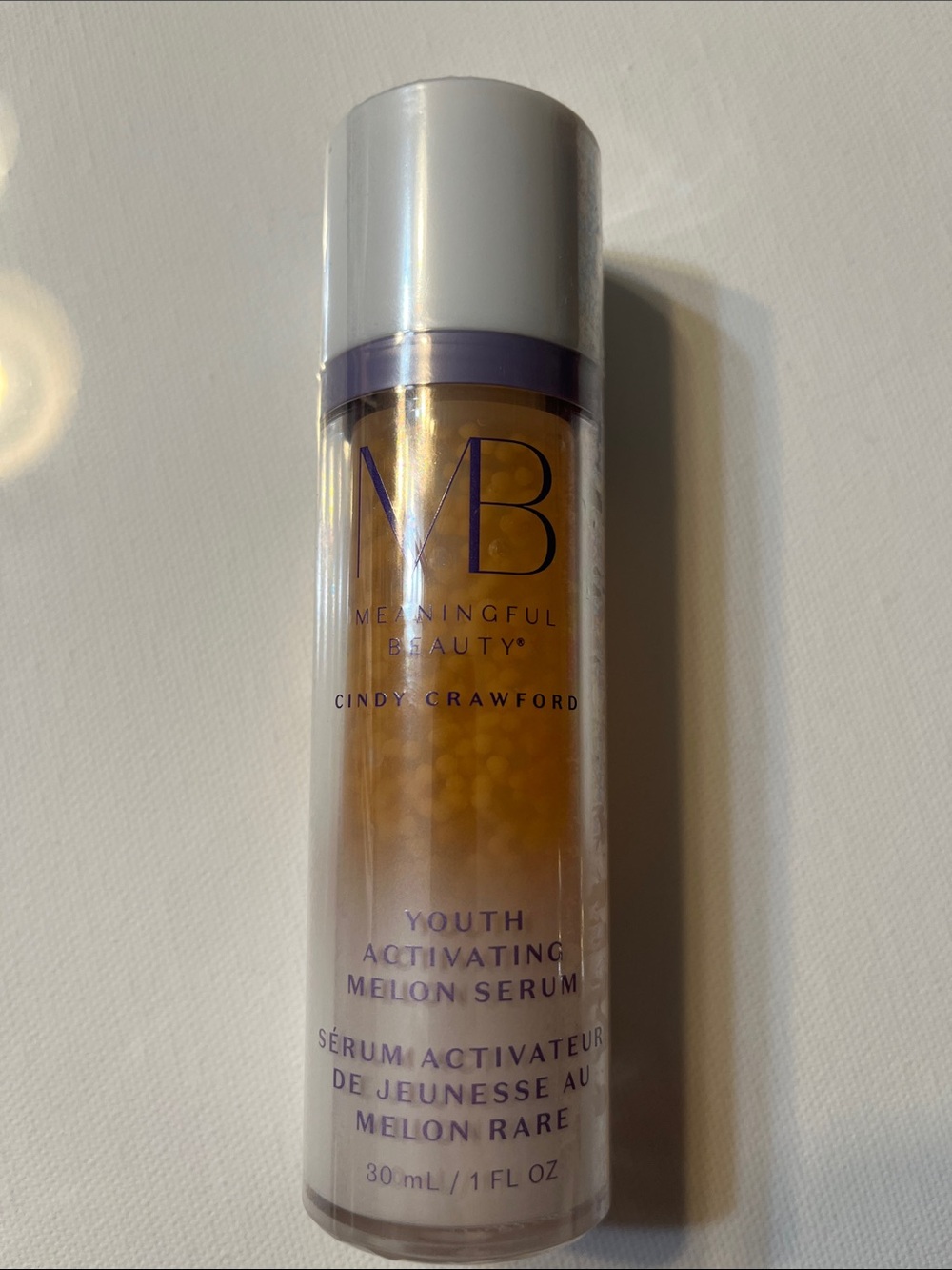 Meaningful Beauty Melon Serum with Purple Accents and Gold Capsules